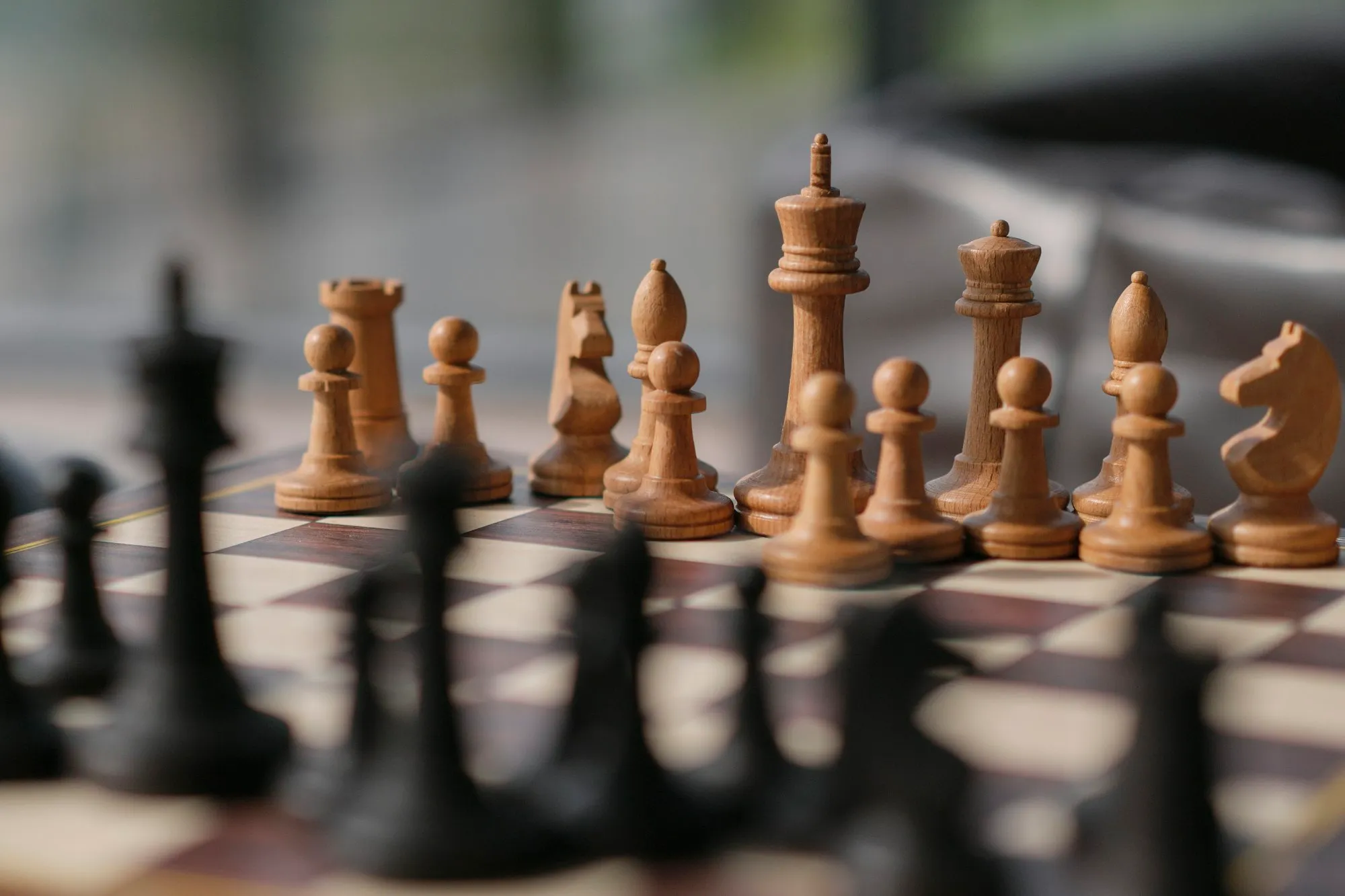 A chessboard, photo by Denis Volkov (@mrparalloid) on Unsplash